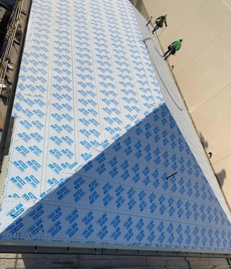 Professional roofers installing underlayment on a metal roof in Statesboro